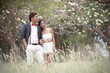 couples of asian man and women in the blooming flowers park