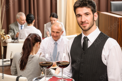 Photo: Waiter hold wine glasses business lunch restaurant Waiter hold wine glasses business lunch restaurant