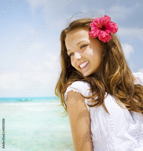 Photo: Beautiful Girl in Tropical Resort. Travel and Vacation concept Beautiful Girl in Tropical Resort. Travel and Vacation concept