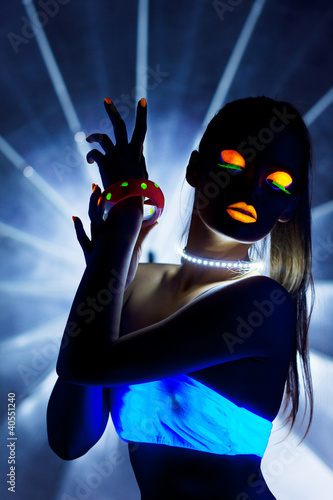 Photo: Disco girl with glow make-up dance in uv light Disco girl with glow make-up dance in uv light