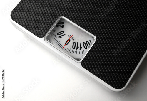Photo: Dieting concept with scales on the white background Dieting concept with scales on the white background
