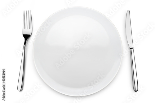 Photo: table set with plate, fork and knife on white background table set with plate, fork and knife on white background