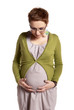 Pregnant woman looking at her belly
