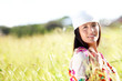 Beautiful gypsy girl with scarf standing in meadow Beautiful gypsy girl with scarf standing in meadow