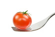A fresh tomato on a fork on a white background