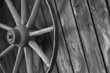 Old cart wheel against wall
