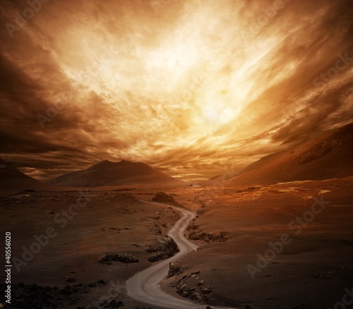 Photo: Dramatic sky over road in a valley. Dramatic sky over road in a valley.