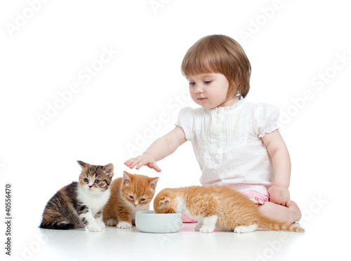 Photo: funny child feeding attractive kitten funny child feeding attractive kitten
