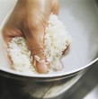 A Handful of Rice Being Rinsed
