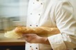 Chef with baguette under his arm