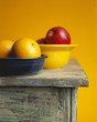 Two Bowls of Fruit on a Table; Oranges and Apples
