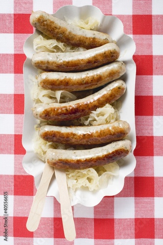 Photo: Sausages with sauerkraut on paper plate Sausages with sauerkraut on paper plate