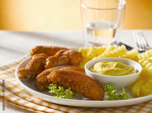 Photo: Chicken wings with curry dip and chips Chicken wings with curry dip and chips