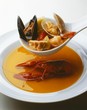 Ladling Seafood Stew into Bowl