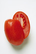 Plum tomatoes with drops of water (halved)