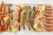 Various types of shrimps with lemons on crushed ice