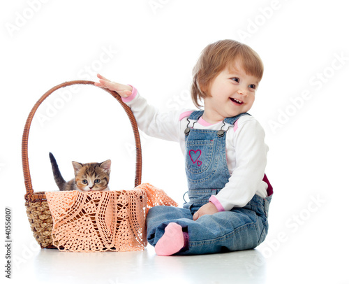 Photo: Smiling child sitting down by basket with kittens, isolated on w Smiling child sitting down by basket with kittens, isolated on w