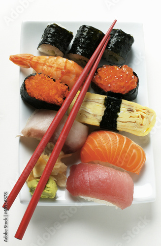 Photo: Mixed sushi platter with red chopsticks Mixed sushi platter with red chopsticks