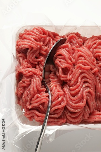Photo: Fresh minced beef in plastic container with spoon Fresh minced beef in plastic container with spoon