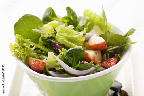 Photo: Spring salad with red onions and strawberries in bowl Spring salad with red onions and strawberries in bowl
