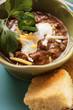 Chili con carne with cheese and sour cream; corn bread