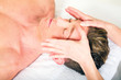 Photo: young man receives a face massage young man receives a face massage