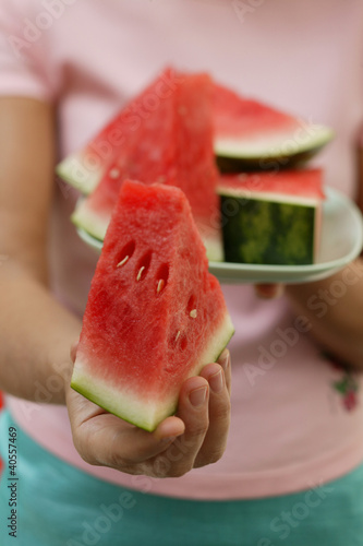 Photo: Woman holding wedge of watermelon Woman holding wedge of watermelon