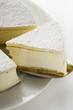 Cream cheesecake, a piece cut, with piece on server