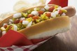 Hot dog with relish, mustard, ketchup, onions and crisps