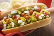 Hot dog with relish, mustard, ketchup, onions and crisps