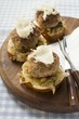 Burgers with onions and horseradish on pretzels