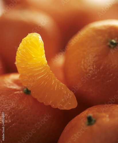 Photo: Whole tangerines and one segment Whole tangerines and one segment