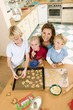 Photo: Mother and three children baking biscuits Mother and three children baking biscuits