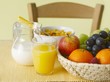 Still life with juice, fruit, milk and cornflakes