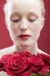 Young woman with a bouquet of red roses