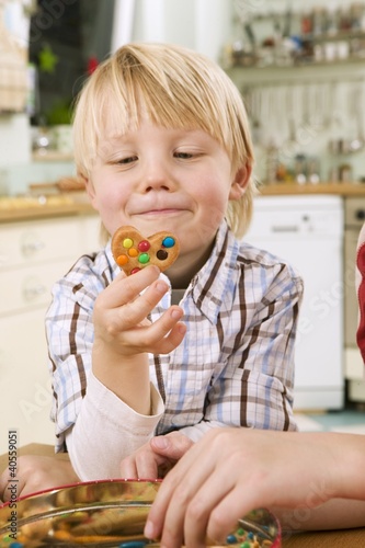 Photo: Boy holding a biscuit Boy holding a biscuit