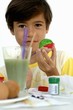 Boy painting Easter eggs