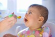 Baby being fed baby food