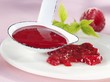 Raspberry sauce on plate and in ladle