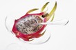Half a pitahaya in glass bowl with teaspoon