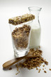 Crunchy muesli, muesli bar and carafe of milk