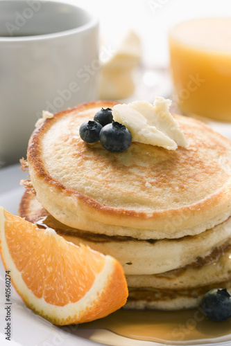 Photo: Pancakes with butter and fruit for breakfast Pancakes with butter and fruit for breakfast
