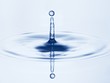 Drop of water falling into water and making ripples
