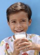 Small boy drinking a glass of milk