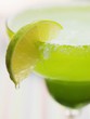 Lime wedge on cocktail glass with sugared rim