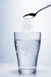 Sprinkling salt into a glass of water