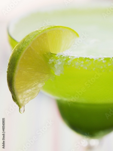 Photo: Lime wedge on cocktail glass with sugared rim Lime wedge on cocktail glass with sugared rim