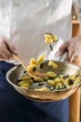 Tossing sage gnocchi in a frying pan