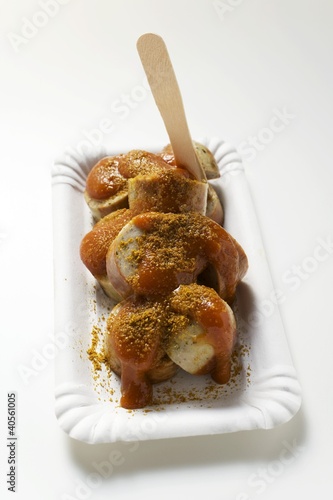 Photo: A currywurst (sausage with ketchup & curry powder) with wooden fork A currywurst (sausage with ketchup & curry powder) with wooden fork