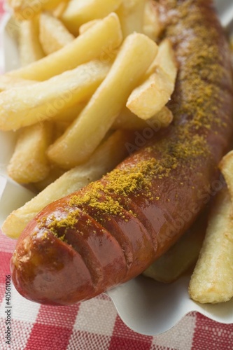 Photo: Currywurst with chips in a paper dish Currywurst with chips in a paper dish